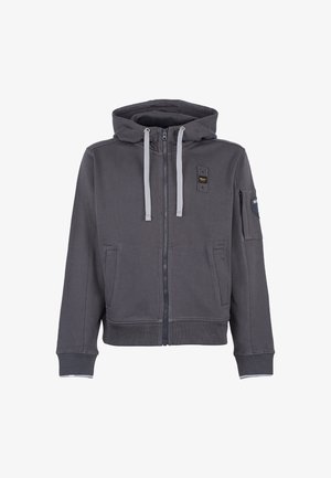 Felpa grigia con zip, dotata di cappuccio regolabile con cordino, due tasche anteriori e una tasca sulla manica. Presenta dettagli grigi a contrasto e una texture di stoffa morbida.