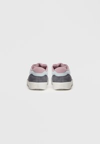 Et par grå og rosa Nike SB joggesko vist fra baksiden på en hvit bakgrunn.