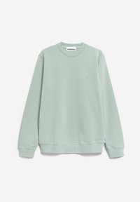 Vaalean mintunvihreä collegepaita, joka on valmistettu pehmeästä kankaasta. Siinä on pyöreä kaula-aukko, resorit hihansuissa sekä pieni rintakehälle kirjailtu logo.