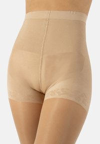Shorts modellanti beige con una texture liscia e elastica, design a vita alta e un sottile motivo floreale ai lati delle aperture delle gambe.