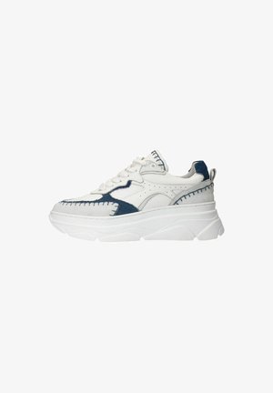 White sneaker with blue suede accents, featuring raised stitching, a thick white sole, and lace-up design. Notable for distinct paneling.