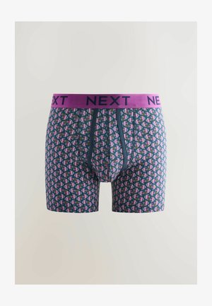 Marineblauwe boxershorts met een geometrisch patroon in roze, paars en groen. Beschikt over een paarse elastische tailleband met "NEXT" merknaam.