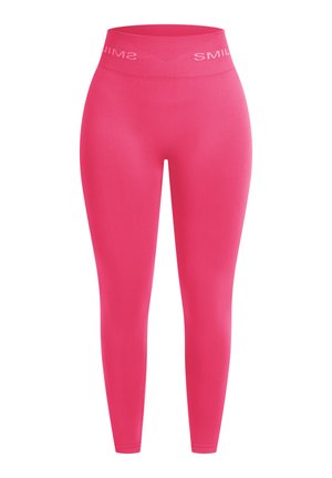 Leggings rose pleine longueur avec une texture lisse et un tissu extensible. Dotés d'une large ceinture avec le mot "SMILE" imprimé en blanc contrasté.