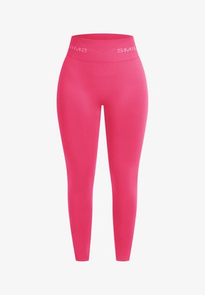 Leggings rosas de longitud completa con una textura suave y tela elástica. Presentan una cinturilla ancha con "SONRÍE" impreso en blanco en contraste.