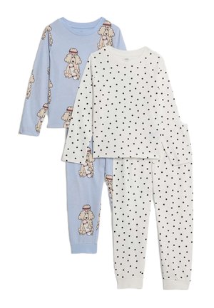 Två uppsättningar barnens långärmade pyjamaser: en ljusblå med pudelhundtryck, en vit med svarta prickar.