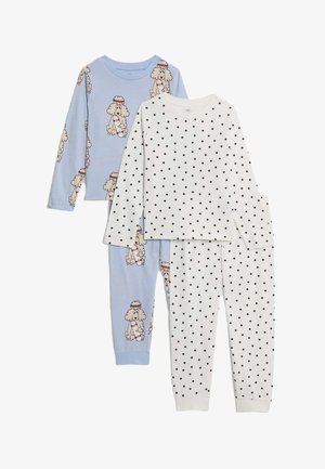 Two sets of children's long-sleeve pajamas: one light blue with poodle dog print, one white with black polka dots.