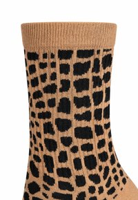 Calze con stampa leopardata nei toni del marrone e del nero. Tessuto a coste nella parte superiore, con un motivo di macchie grandi e piccole su tutta la superficie.