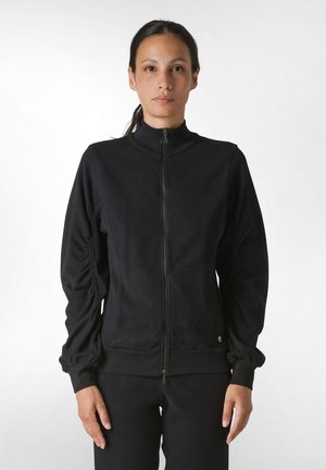Jacket negru cu fermoar, cu guler înalt, mâneci creionate și manșete ribbate. Fabricată din material moale, concepută pentru un aspect strâns.