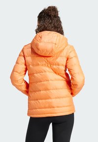Orange puffer jacket with a hood, featuring horizontal quilted design and smooth texture. Suitable for warmth and comfort.