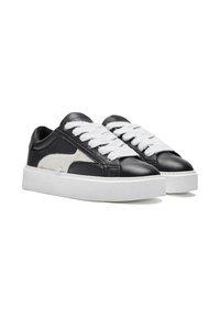 Black leather sneakers with a white faux fur accent, flat white laces, and a thick white rubber sole. Smooth texture with stitched detailing.
