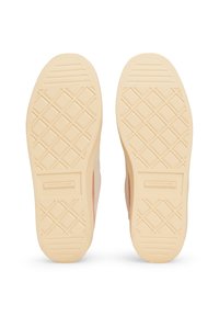 Shoe soles with a diamond pattern, beige rubber material, featuring a pink accent on the side and branded logo near the heel.
