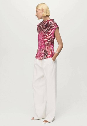 Haut à manches courtes en imprimé animal rose et blanc, fabriqué en tissu léger. Assorti à un pantalon blanc ample. Encolure simple et coupe décontractée.