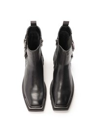 Black leather ankle boots with a square toe, featuring a side zipper and decorative metal buckle accent. Smooth texture and sturdy sole.