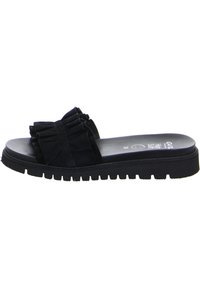 Black sandal featuring a textured fabric upper with a bow detail, a cushioned footbed, and a thick, ridged rubber outsole for grip.