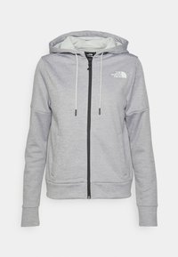 Sudadera con cremallera de color gris claro, con bolsillos delanteros, capucha con cordón, mangas largas y el logotipo blanco de "The North Face" en el pecho.