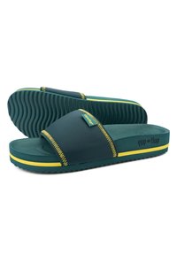 Green slide sandals with a wide strap, featuring yellow stitching and accents. Textured rubber sole with a wave pattern for grip.