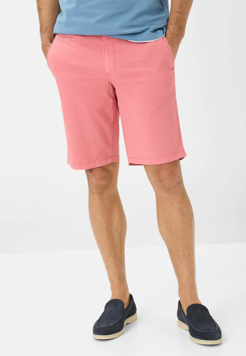 Shorts in cotone rosa con un design casual, tasche frontali e orlo pulito. Abbinati a mocassini blu per un look rilassato.