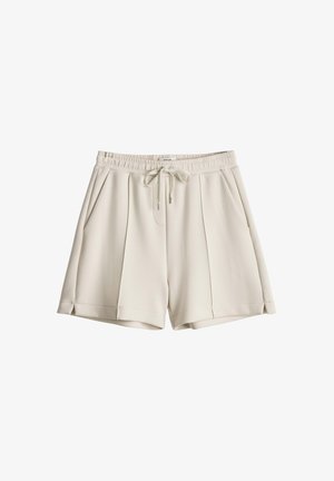 Pantaloncini beige chiaro con vita elastica, coulisse frontale, tasche laterali e dettagli plissettati, realizzati in tessuto liscio.