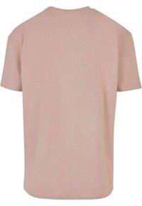 Kortærmet t-shirt i blødt pink stof med ribbet tekstur, med rund halsudskæring og lige søm. Minimalistisk design, uden grafik.