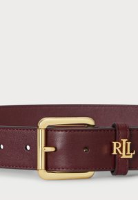 Burgundijas ādas josta ar zelta tonī kvadrātveida sprādzi un iegravētu "RL" logo. Ietver šuvju akcentus un vairākus regulēšanas caurumus.