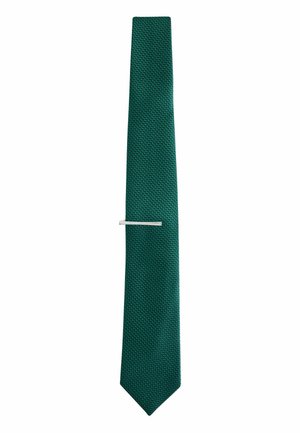 Green textured necktie with a silver tie clip placed horizontally at mid-length, displayed against a plain white background.