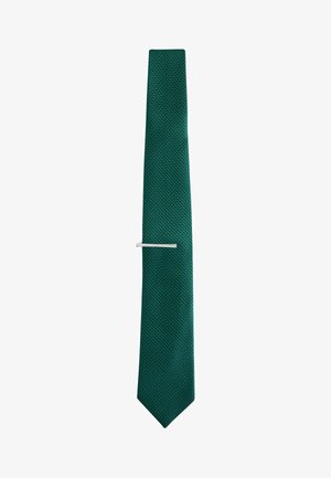 Green textured necktie with a silver tie clip placed horizontally at mid-length, displayed against a plain white background.