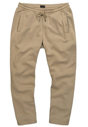 Béžové tepláky z měkkého materiálu, s elastickým pasem na šňůrku a dvěma bočními kapsami. Subtilní brandingový detail na noze.