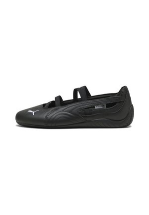 Black synthetic athletic shoe with textured design, open cutouts, two elastic straps, and contrasting white logo on the toe.