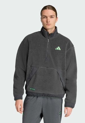 Gray fleece pullover with a half-zip front, drawstring hem, front pocket, and green logo accents. Soft texture and relaxed fit.
