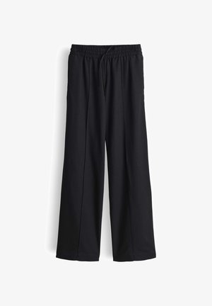 Schwarze, weit geschnittene Hose mit elastischem Bund und vorderem Kordelzug, aus glattem Stoff, vor weißem Hintergrund abgebildet.