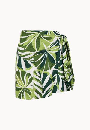 Grüner und weißer Wickelrock mit tropischem Blattmuster und Seitenschleifen-Detail vor einem einfarbigen Hintergrund.