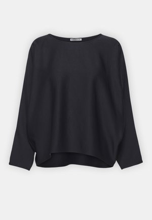 Black, loose-fitting top with a rounded neckline and three-quarter sleeves. Smooth fabric with a slight sheen and asymmetric hemline.