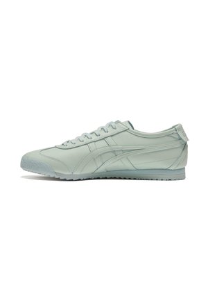Light mint green sneakers made of smooth leather. Features include a low profile, rounded toe, and textured rubber sole with grooves.