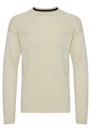 Dugi rukavičasti kremasti sako s teksturiranim pletenim uzorkom, okruglim izrezom i crnim detaljem na ovratniku. Ima raglan rukave.