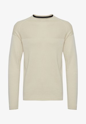 Pikkade varrukatega kreemjasärgid, millel on tekstuuriga kudumismuster, ümmargune kaelus ja must aktsent kaelas. Omab raglan varrukaid.