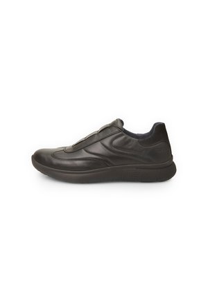 Black leather slip-on shoe with a smooth finish, padded collar, and textured rubber sole. Features subtle design lines and no visible hardware.
