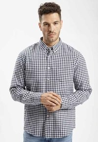 Czarna i biała koszula w kratkę typu button-up, z długimi rękawami, z bawełny, z rozkładanym kołnierzem, z jedną kieszenią na piersi oraz kontrastowymi detalami przy guzikach.