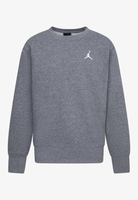 Felpa grigia a maniche lunghe con colletto rotondo, dotata di polsini e orlo a coste, caratterizzata da un piccolo logo Jumpman bianco sul lato sinistro superiore del petto.