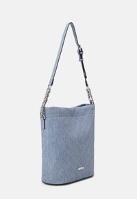 Jasnoniebieska jeansowa torba typu bucket z pikowanym wzorem w jodełkę, posiadająca pasek z łańcuszkiem oraz miękką, teksturowaną powierzchnię.