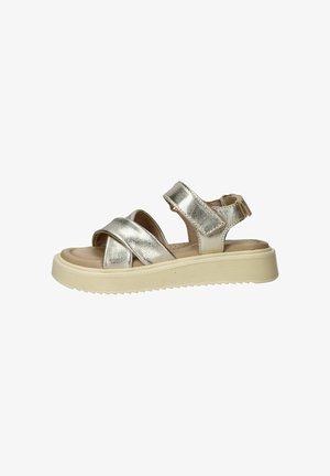 Zilverkleurige metallic sandaal met gekruiste bandjes, klittenbandsluiting bij de enkel, gevoerd voetbed en dikke geribbelde beige zool.