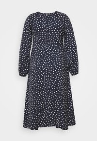 Marineblaues Kleid mit langen Ärmeln und hohem Kragen, versehen mit einem weißen Punkte-Muster und einem Reißverschluss auf der Rückseite. Glatte Stoffoberfläche.