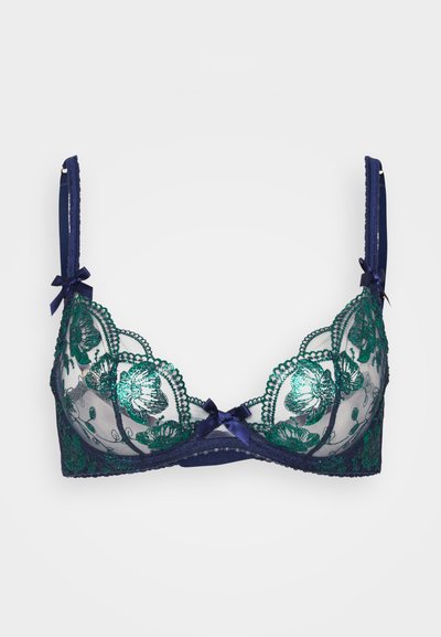 Navy blue lace-rintanaisli rintamojakkureita vihreillä kukka-embroidereilla, läpinäkyvillä kupuilla, aaltoilevilla reunoilla ja koristeellisia viiksiä hihnoilla. Sisältää hienovaraisia yksityiskohtia.