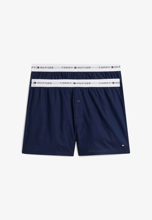 Δύο ζευγάρια σκούρα μπλε boxer Tommy Hilfiger με άσπρες ελαστικές μέσες που φέρουν το όνομα και το λογότυπο της μάρκας.