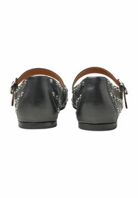 Svarta läder skor utan häl med metalliska nitar och en läderrem med spänne. Slät textur och rundad form.