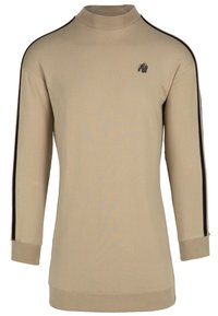 Camiseta de manga larga beige con cuello alto, rayas laterales negras y un pequeño diseño gráfico en el pecho. Material suave con un ajuste relajado.