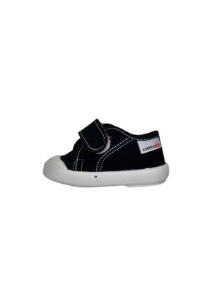 Sneaker per bambini bianco e nero con cinturino in velcro, suola bianca, cuciture visibili ed etichetta del marchio Superga sul lato del tallone.