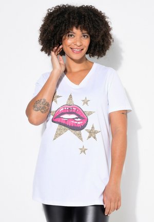 Camiseta blanca con cuello en V que presenta un gráfico de labios rosados y estrellas con estampado de leopardo. Mangas cortas, corte holgado y textura suave.