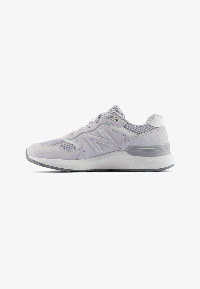 Baskets New Balance gris clair avec des panneaux en mesh et en daim, semelle intermédiaire blanche et semelle extérieure grise, vues de côté sur fond blanc.