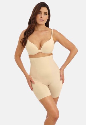 Soutien-gorge beige sans couture avec un design à décolleté plongeant et un short de shapewear taille haute assorti, présentant une texture lisse et extensible.