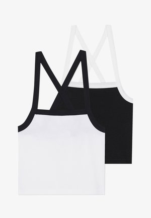 Deux tops en coton, l'un blanc et l'autre noir, présentent des bretelles croisées dans le dos et une texture côtelée. Chacun a une bordure contrastante le long des bords.